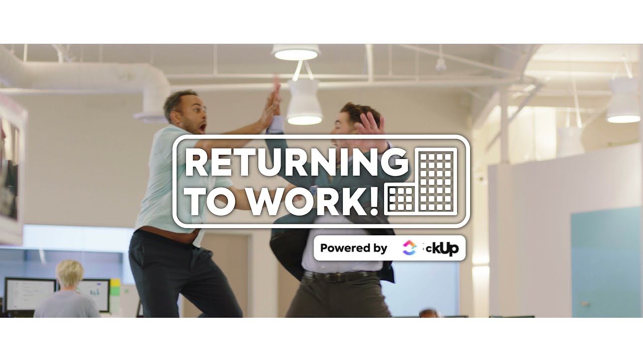 Two people awkwardly high fiving after returning to the office.